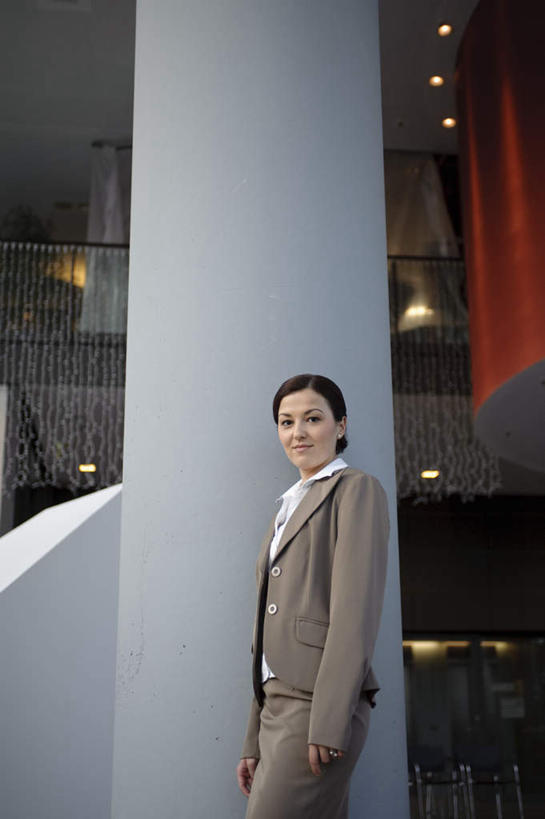 西方人,一个人,商务人士,商务女性,办公室,站,笑,微笑,竖图,室内,白天,侧面,欧洲,欧洲人,仅一个年轻女性,仅一个女性,仅一个人,阴影,套装,反射,光线,瓷砖,地砖,影子,柱子,灯光,地面,注视,大厅,观察,看,靠,靠着,站着,观看,察看,关注,商务装,工薪阶层,年轻女性,女人,女性,白种人,白领,上班族,站立,半身,彩图